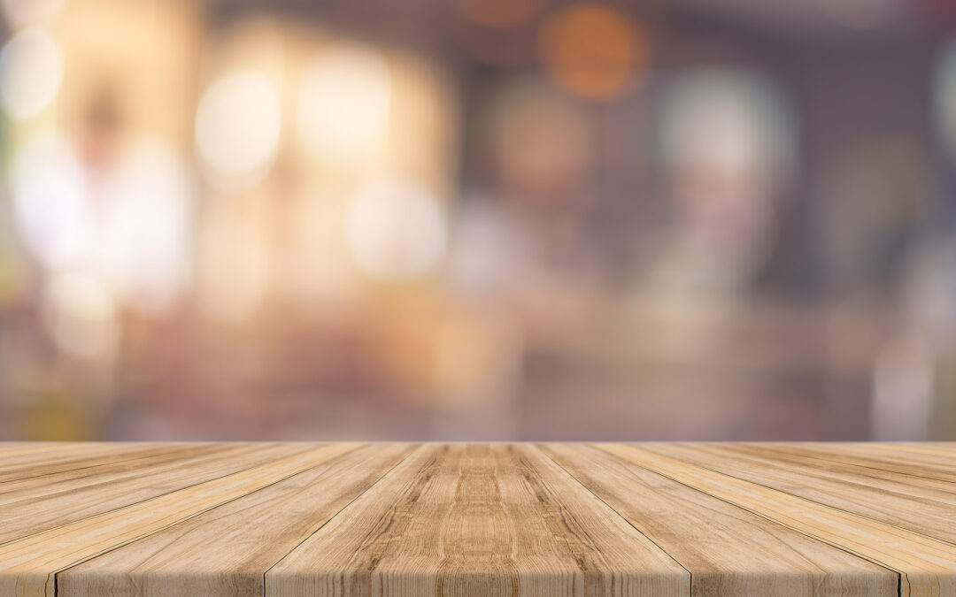 Wooden board empty table blur in coffee shop.